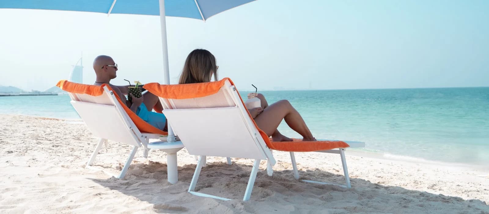 Two guests relaxing on sunbeds at Sole Mio on Kite Beach